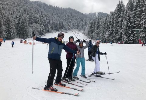 Family having fun during group ski lessons in Poiana Brasov.